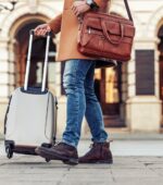 Close up of man carrying suitcase